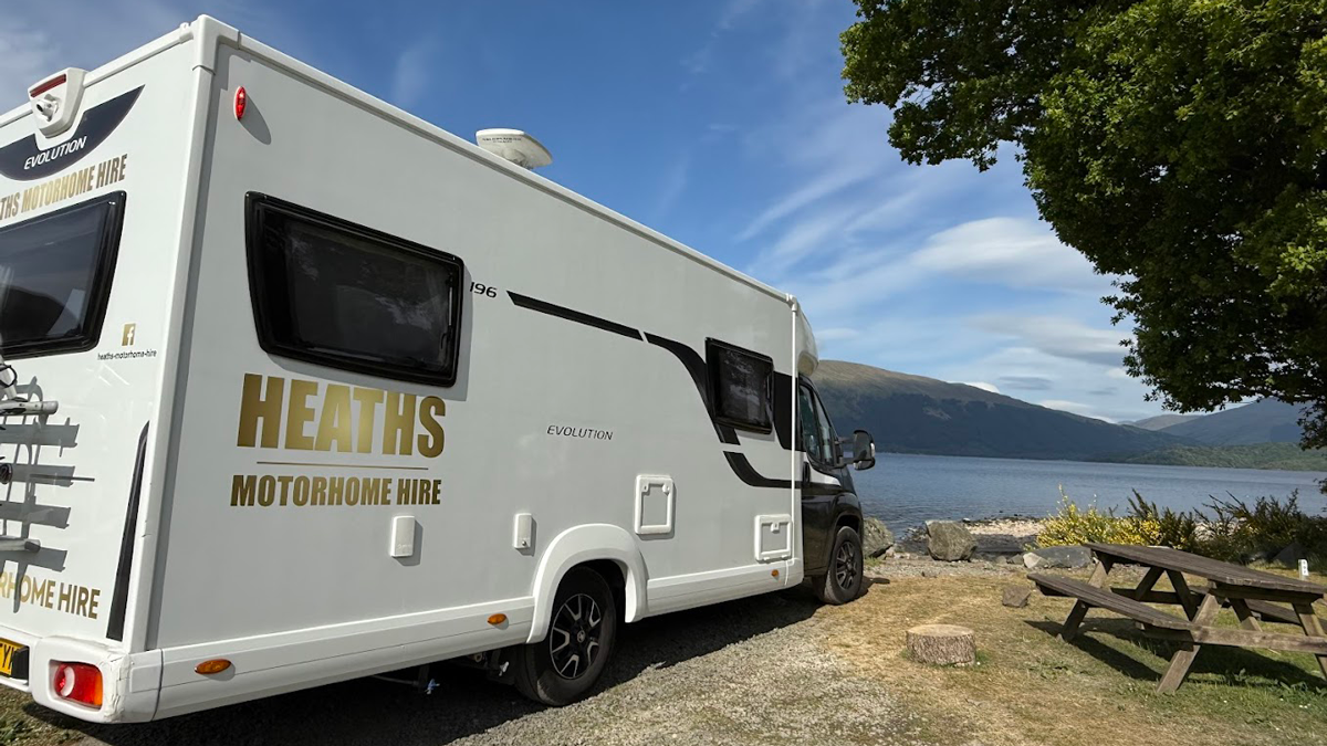 Heaths Motorhome Hire motorhome pitched beside a Scottish loch with mountains in the distance
